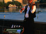 A violinist busks on the Charles Bridge over the Vltava river.