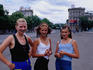 Portrait of three females in street.