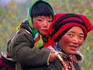 Tibetan woman carrying a young child on her back.