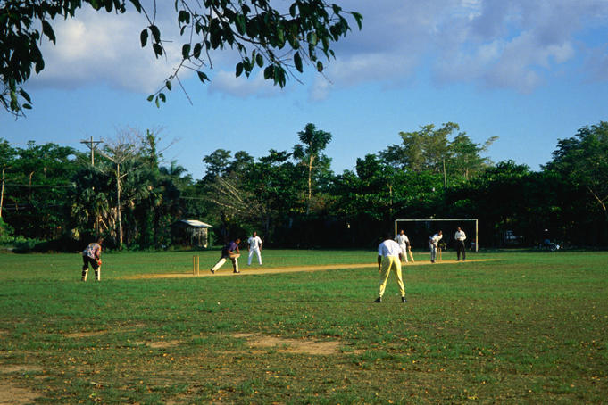 Playing cricket in Long Bay beach park.