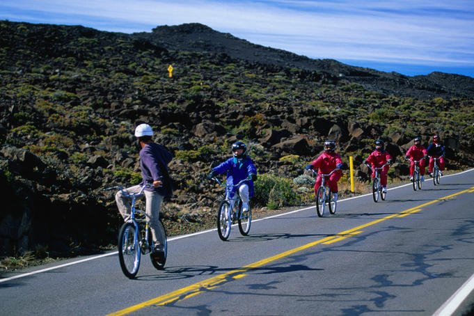 Cyclists coasting down the roads of Haleakala Crater.