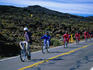 Cyclists coasting down the roads of Haleakala Crater.