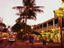 The Pioneer Inn and people shopping on Front Street at dusk.