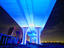 Underneath of freeway illuminated at night.