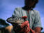 An Iguana reseacher holding an Iguana.