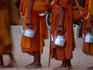 Saffron robed monks queue during an event at the ancient site of Angkor.