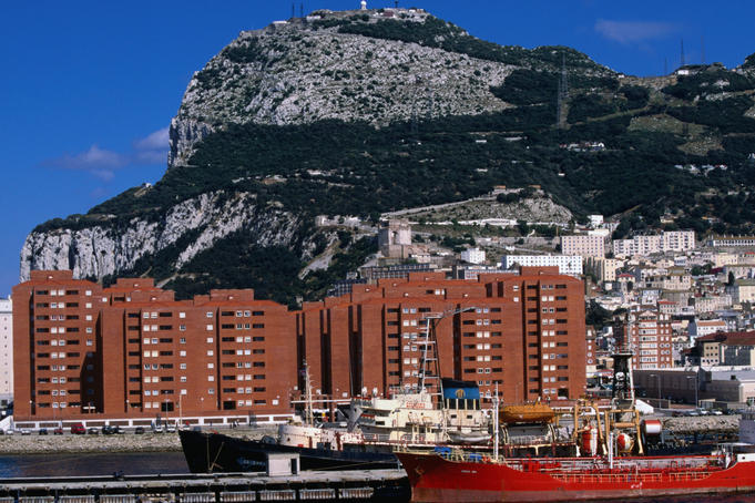 Port and apartment blocks beneath rock of Gibraltar.