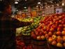 A shopper selecting apples in the Freshfields/Whole Foods Market on P Street.
