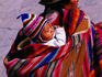 Traditionally dressed child on mother's back.