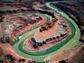 Aerial view of the distinctively green waters of the Colorado River cutting through red cliffs at The Gooseneck, in the Canyonlands National Park.