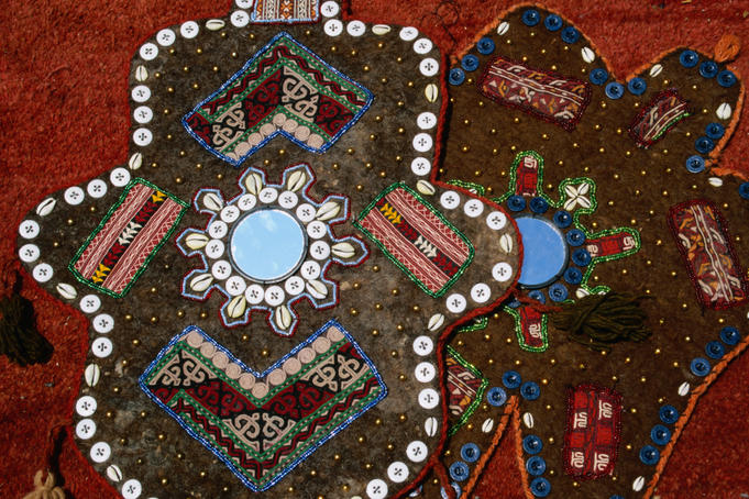 Craft decoration with inlaid buttons and mirrors.