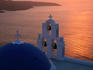 Classic views of the blue-domed churches of Fira under a firey sunset.