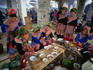 Women from the Flowery Hmong community, one of the many ethnic minority groups living in Vietnam today, eating at a noodle shop in Bac Ha Markets