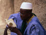 Man reading his Koran outside the Djenne Mosque.