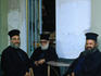 Greek orthodox priests sitting at a coffee shop.