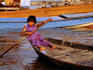 Girl paddling boat in Vietnamese village near Siem Reap.