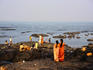 Mumbai locals enjoy a cool sea breeze behind the Mahalaxmi Temple