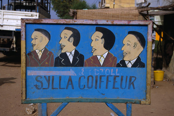 One of many hand-painted roadsigns for hair salons found throughout Senegal.
