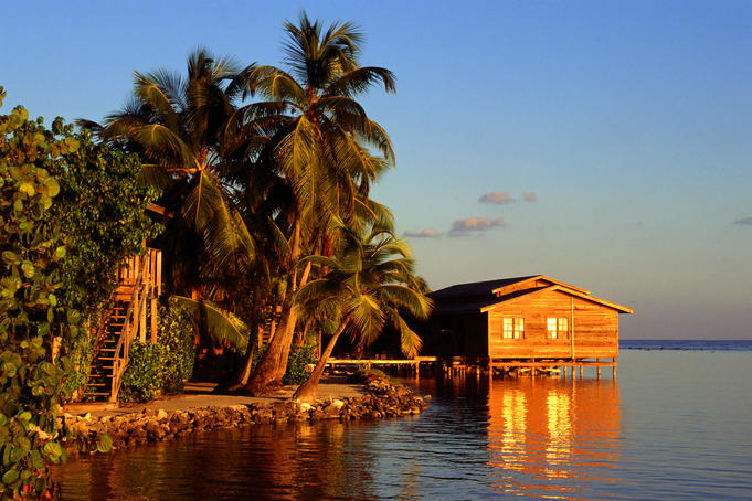 Early evening sunlight over the beach huts at Roatan's Cocoview Resort.